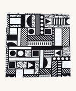 A Etta Loves x Camille Walala XL Muslin Square in Monochromatic shapes design folded up into a square on a plain background. 