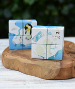 Bajo 2-in-1 polar jungle wooden cube block puzzle placed on a wooden surface in two stack featuring the polar design side.