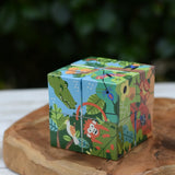 Bajo 2-in-1 polar jungle wooden cube block puzzle placed on a wooden surface shown on the jungle design side.