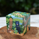 Bajo 2-in-1 polar jungle wooden cube block puzzle placed on a wooden surface shown on the jungle design side.