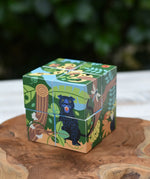 Bajo 2-in-1 polar jungle wooden cube block puzzle placed on a wooden surface shown on the jungle design side.