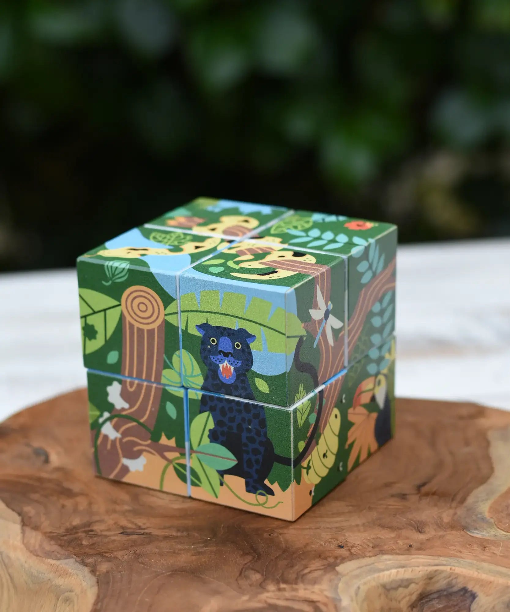 Bajo 2-in-1 polar jungle wooden cube block puzzle placed on a wooden surface shown on the jungle design side.