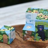 Bajo 2-in-1 polar jungle wooden cube block puzzle placed on a wooden surface with one block taken out of the cube.