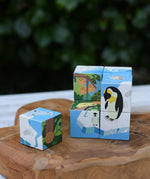 Bajo 2-in-1 polar jungle wooden cube block puzzle placed on a wooden surface with one block taken out of the cube.