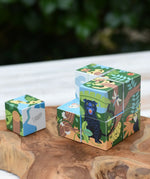 Bajo 2-in-1 polar jungle wooden cube block puzzle placed on a wooden surface with one block taken out of the cube.
