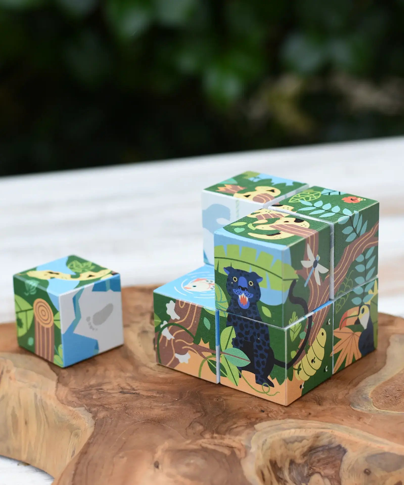 Bajo 2-in-1 polar jungle wooden cube block puzzle placed on a wooden surface with one block taken out of the cube.