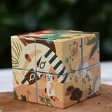 Bajo 2-in-1 reef desert wooden cube block puzzle shown on the desert design side placed on a wooden surface. 