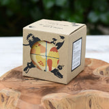 Bajo 2-in-1 reef desert wooden cube block puzzle shown in the cardboard packaging box placed on a wooden surface. 