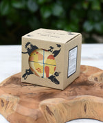 Bajo 2-in-1 reef desert wooden cube block puzzle shown in the cardboard packaging box placed on a wooden surface. 