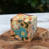 Bajo 2-in-1 reef desert wooden cube block puzzle shown on the desert design side placed on a wooden surface. 