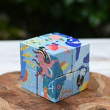 Bajo 2-in-1 reef desert wooden cube block puzzle shown on the reef design side with an octopus, coral, fish and other sea creatures.