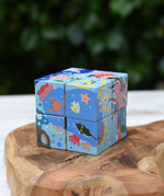 Bajo 2-in-1 reef desert wooden cube block puzzle shown with the reef design side.
