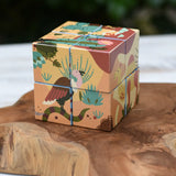 Bajo 2-in-1 reef desert wooden cube block puzzle shown on the desert design side placed on a wooden surface. 