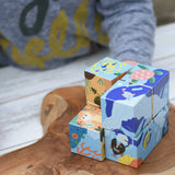 Close up of the Bajo 2-in-1 reef desert wooden cube block puzzle shown on the reef design side with one of the blocks taken away from the cube.