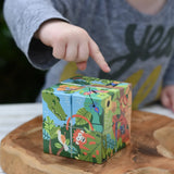 Bajo 2-in-1 polar jungle wooden cube block puzzle placed on a wooden surface shown on the jungle side.