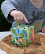 Bajo 2-in-1 polar jungle wooden cube block puzzle placed on a wooden surface shown on the jungle side.
