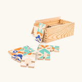 Bajo wooden 3D domino game set showing the pieces with abstract designs next to a wooden storage box