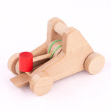 A close up of the A Bajo wooden catapult toy set available available at Babipur showing the elastic pull back system and red base for the balls to sit on