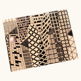 Bajo city puzzle set showing different shaped wooden building pieces with black detailing laid flat