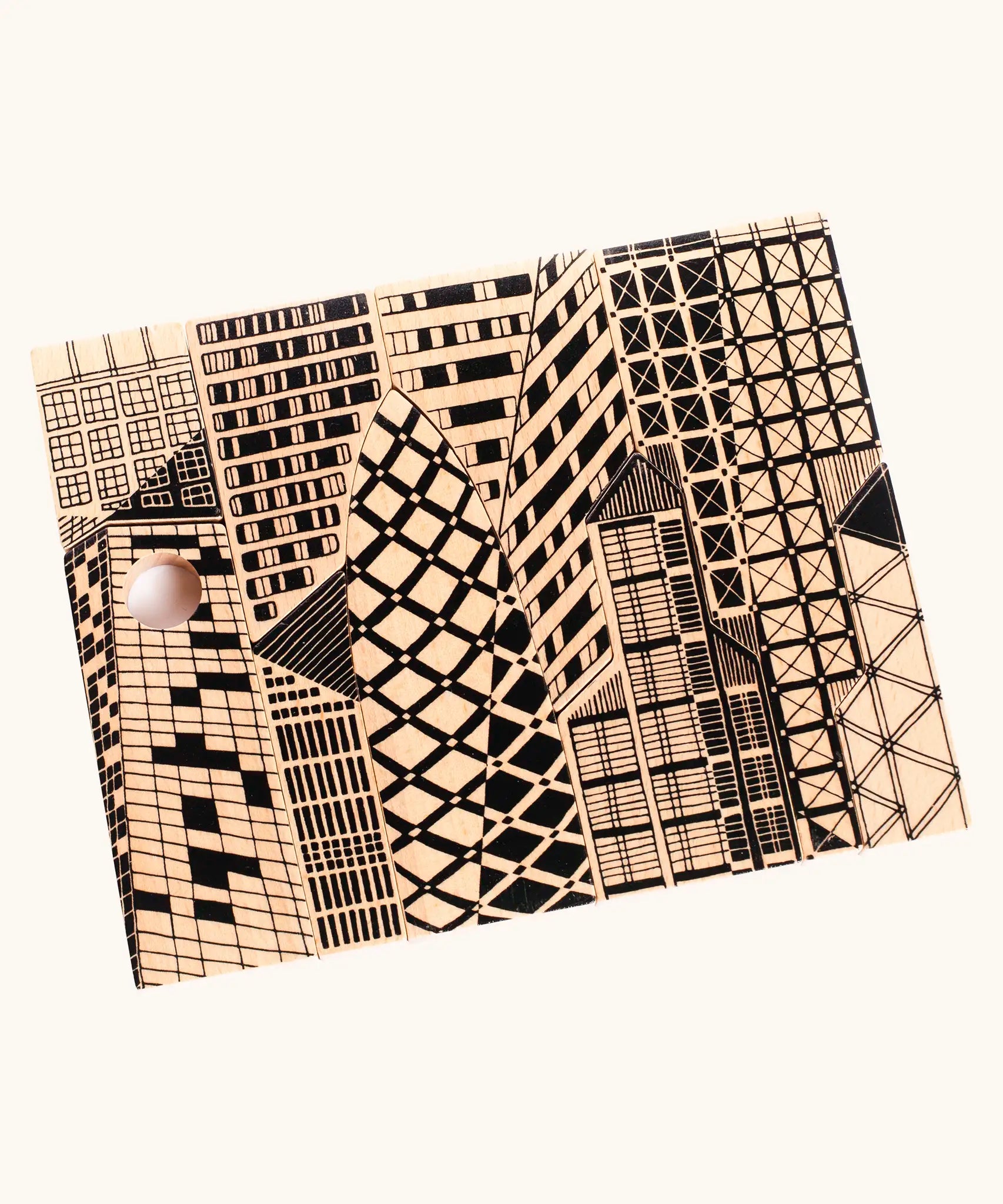 Bajo city puzzle set showing different shaped wooden building pieces with black detailing laid flat