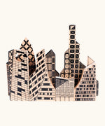 Bajo city puzzle set showing different shaped wooden building pieces with black painted detailing