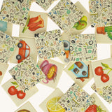 A pile of wooden tiles from the Bajo classic memory game available at Babipur. Showing the different illustrations on the wooden square tiles.