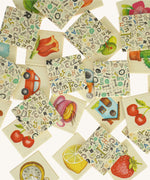 A pile of wooden tiles from the Bajo classic memory game available at Babipur. Showing the different illustrations on the wooden square tiles.