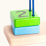 Green wooden block with the number 2 on top from the Bajo count to 5 arched toy