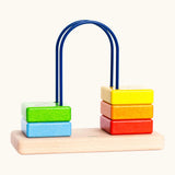 Bajo count to to 5 arched toy showing 5 wooden coloured blocks and unpainted base 