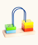 Bajo count to to 5 arched toy showing 5 wooden coloured blocks with a number on one side and fruit on the reverse side  