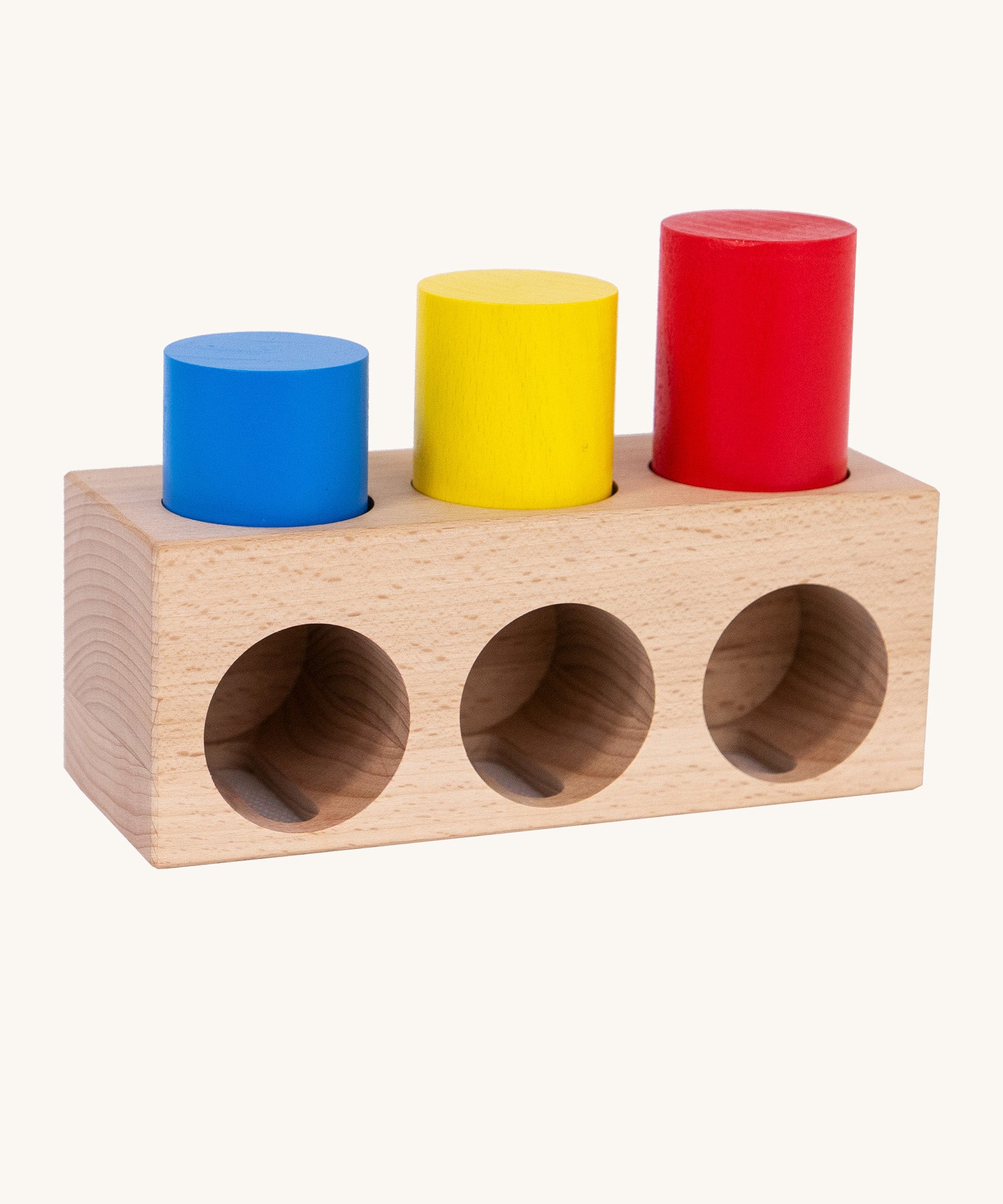 Bajo deep and shallow shape sorter puzzle set available at Babipur. A rectangular shape base with 3 deep cut outs and 3 shallow cut outs. Set includes 3 different coloured wooden tubes in different heights.