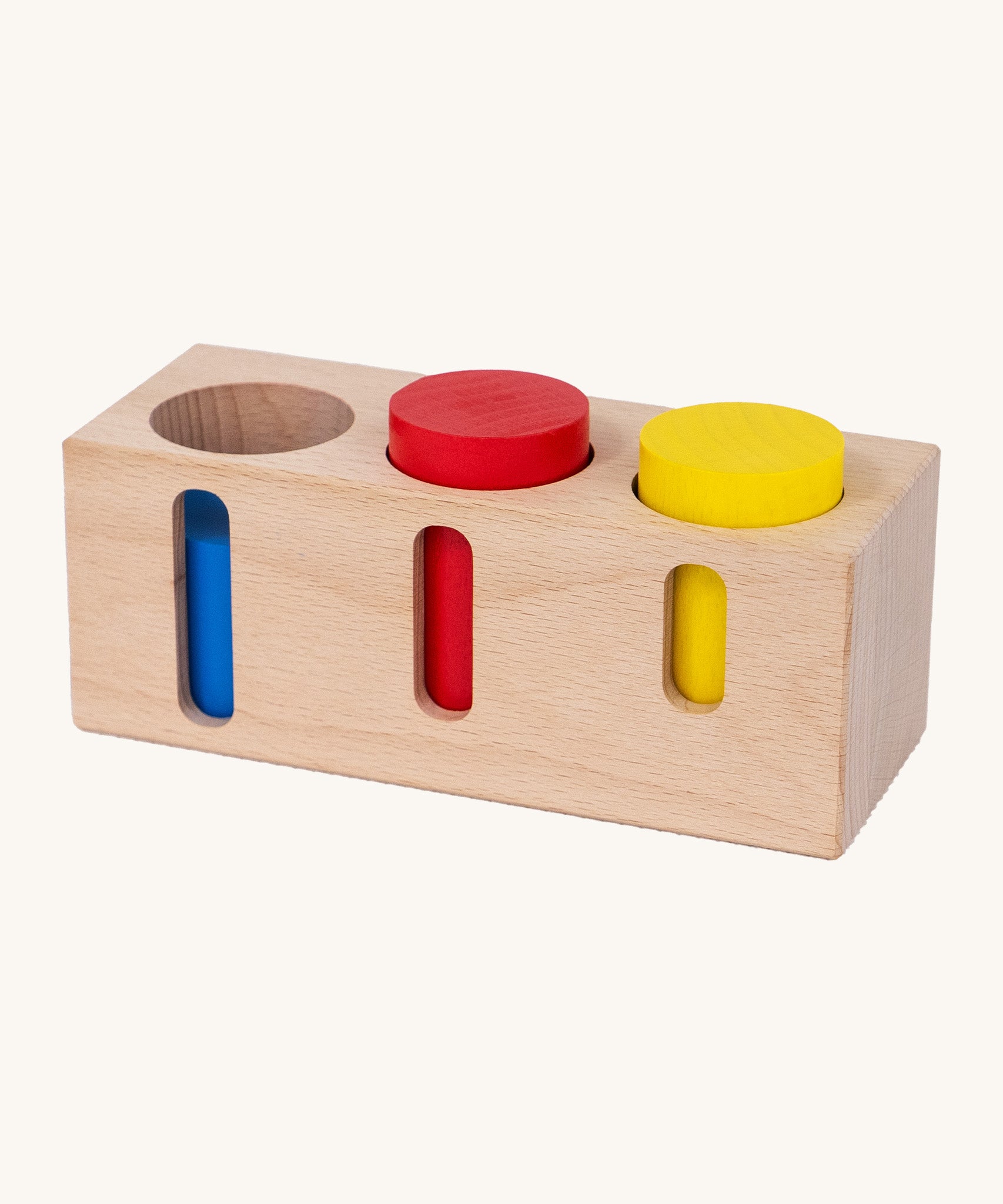 Bajo deep and shallow shape sorter puzzle set available at Babipur. The rectangular shape wooden base has the 3 coloured tubes inside the deep cut outs