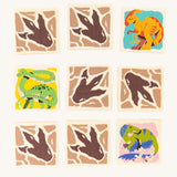9 square pieces from the Bajo Dinosaur Memory Game showing 3 with dinosaur images and 6 with dinosaur foot prints. The footprints are on the back of the blocks and the dinosaur images are on the side that needs to be matched with the same image