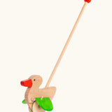 Bajo wooden duck push along toy with wheels and a long handle with a red grip