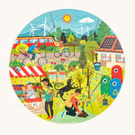 One side of the Bajo Lets Save the Planet wooden puzzle showing a sunny scene with people cycling, a train, a wind farm and people in a garden. On a cream background