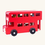 A side image of the red wooden Bajo London Bus, showing the colourful peg doll passengers and a wooden driver inside