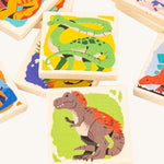A closer look at the square dinosaur memory game pieces from the Bajo Dinosaur Memory Game, showing images of dinosaurs, on a cream background