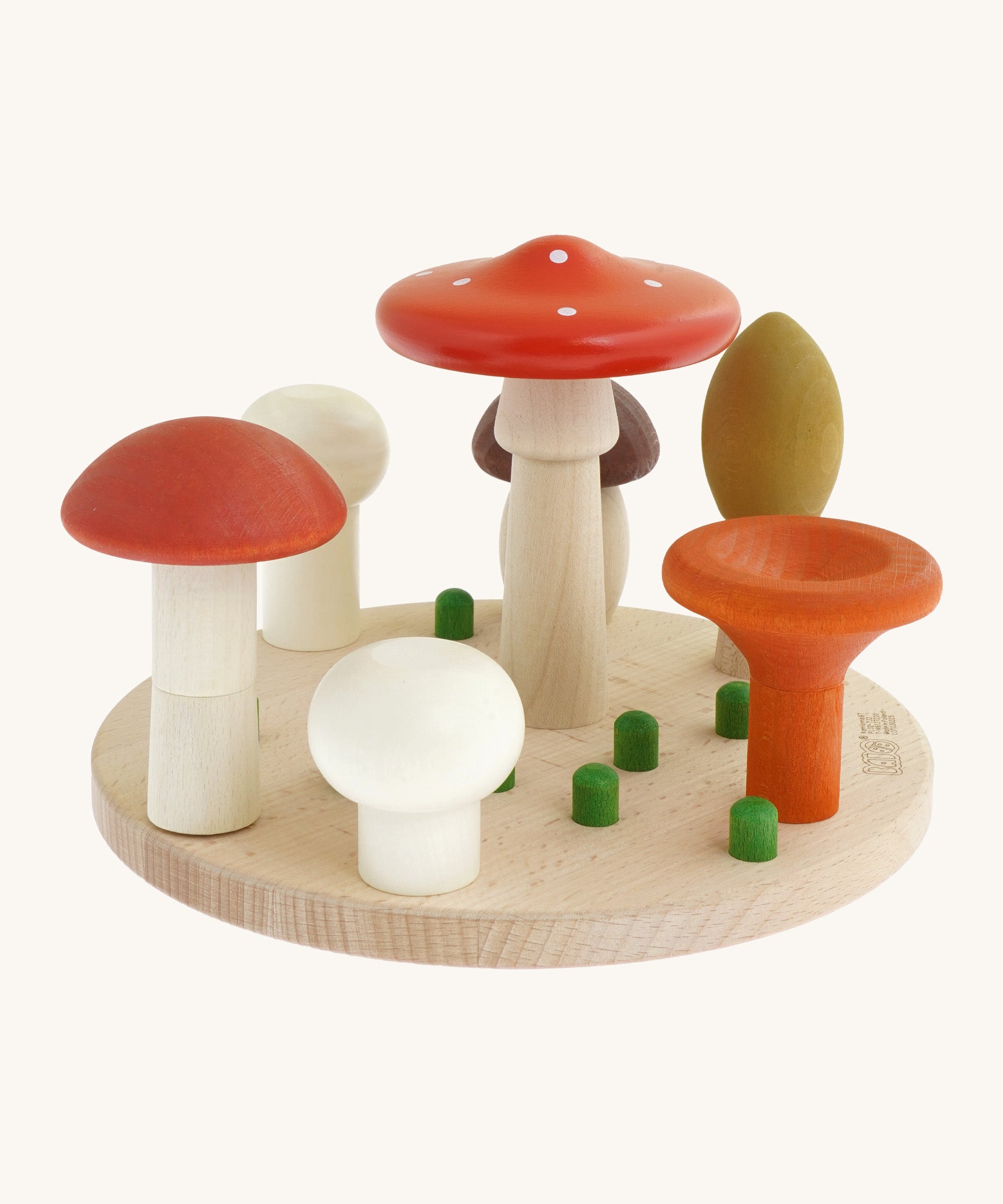 Bajo wooden mushroom shape sorter available at Babipur. Set comes with a wooden circular base with green pegs for 7 different types of mushrooms to slot in