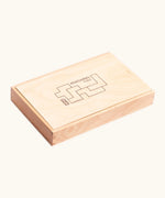 Wooden storage box holding the coloured blocks from the Bajo Pentomino puzzle set