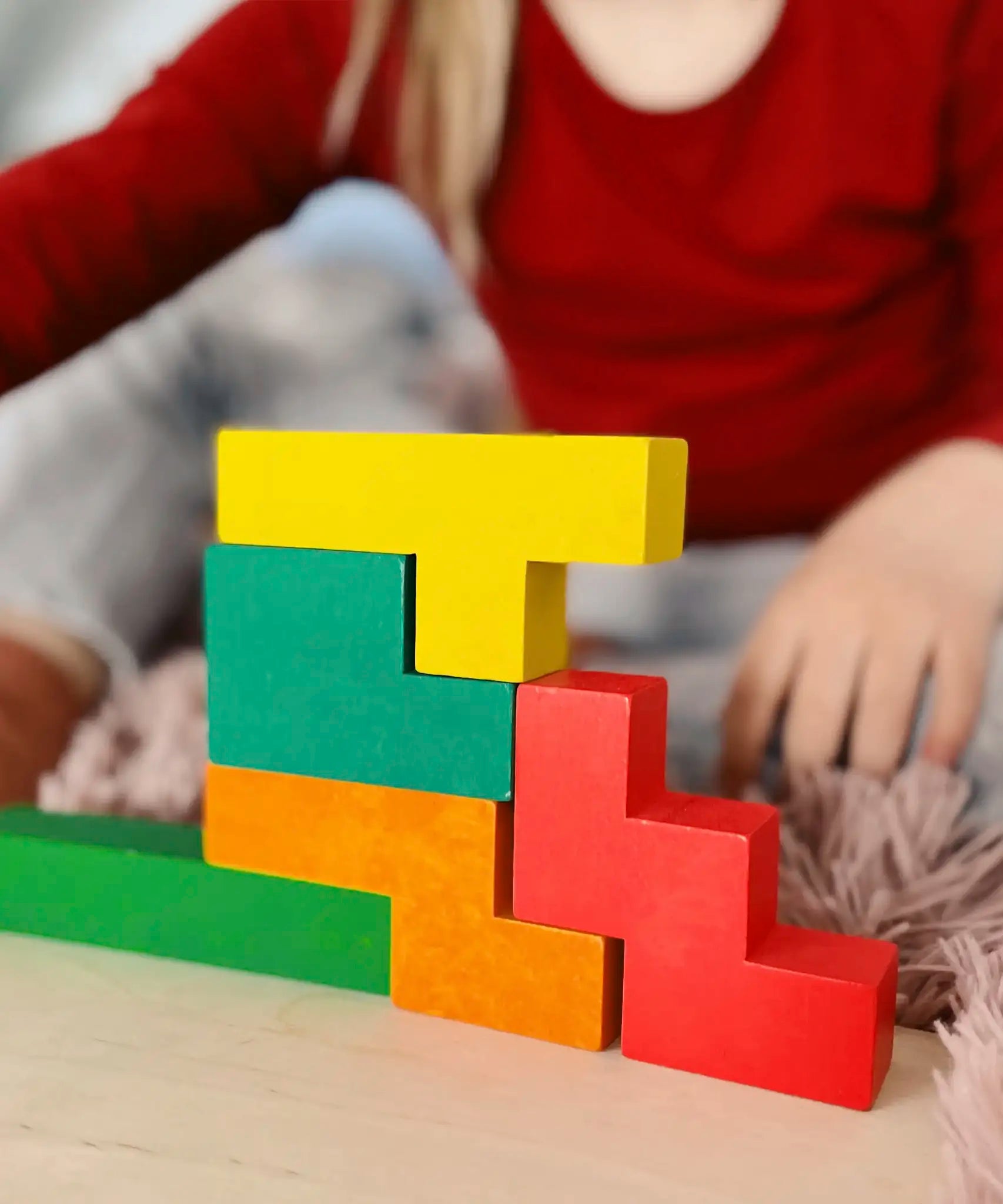 A simple structure made from different Bajo wooden coloured Pentomino puzzle blocks