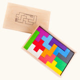 Bajo pentomino set showing different 3d wooden coloured blocks inside a wooden storage box.