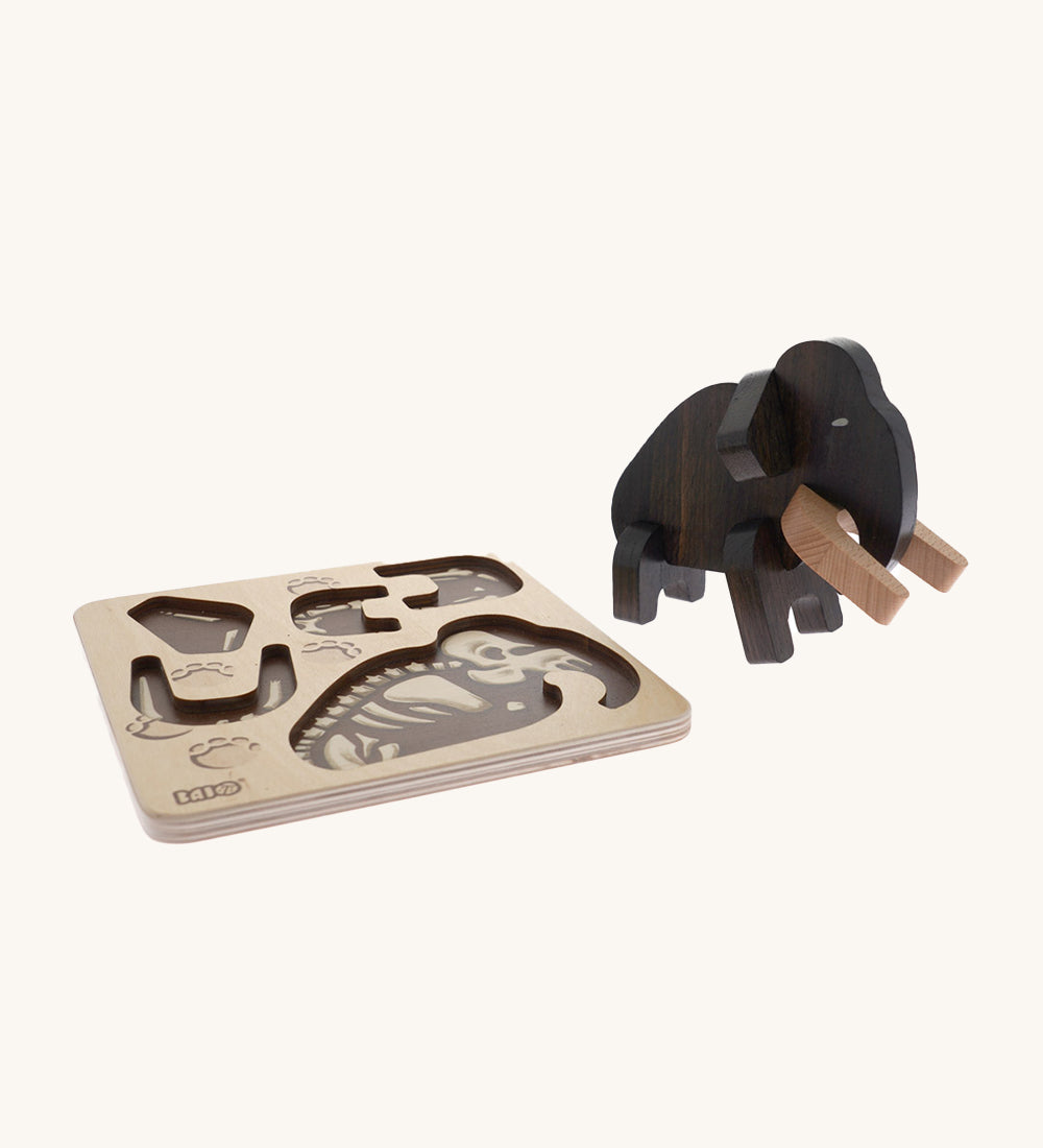 Bajo Puzzle & Sorter - Black Oak Mammoth which has been built and is stood next to it wooden puzzle tray, on a cream background