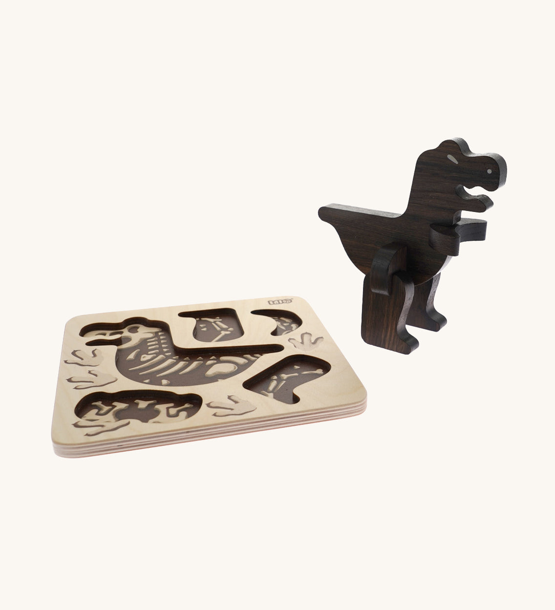Bajo Puzzle & Sorter - Black Oak T-Rex on a cream background. The image shows the build wooden t-rex stood next to is wooden puzzle board