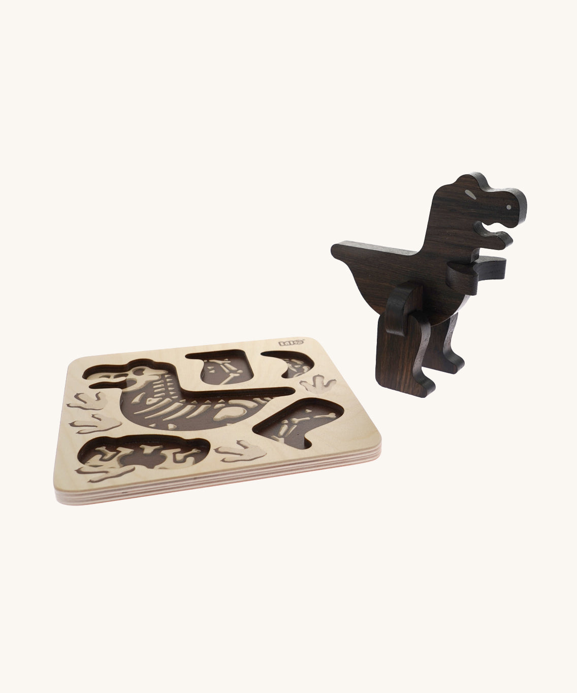 Bajo Puzzle & Sorter - Black Oak T-Rex on a cream background. The image shows the build wooden t-rex stood next to is wooden puzzle board