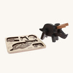 Bajo Puzzle & Sorter - Black Oak Triceratops which has been built and is stood next to its wooden puzzle board on a cream background