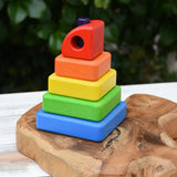 Bajo Puzzle Stacker Tower. A colorful wooden stacking toy set with five nested square blocks in blue, green, yellow, orange, and red, with a purple pole inside. 