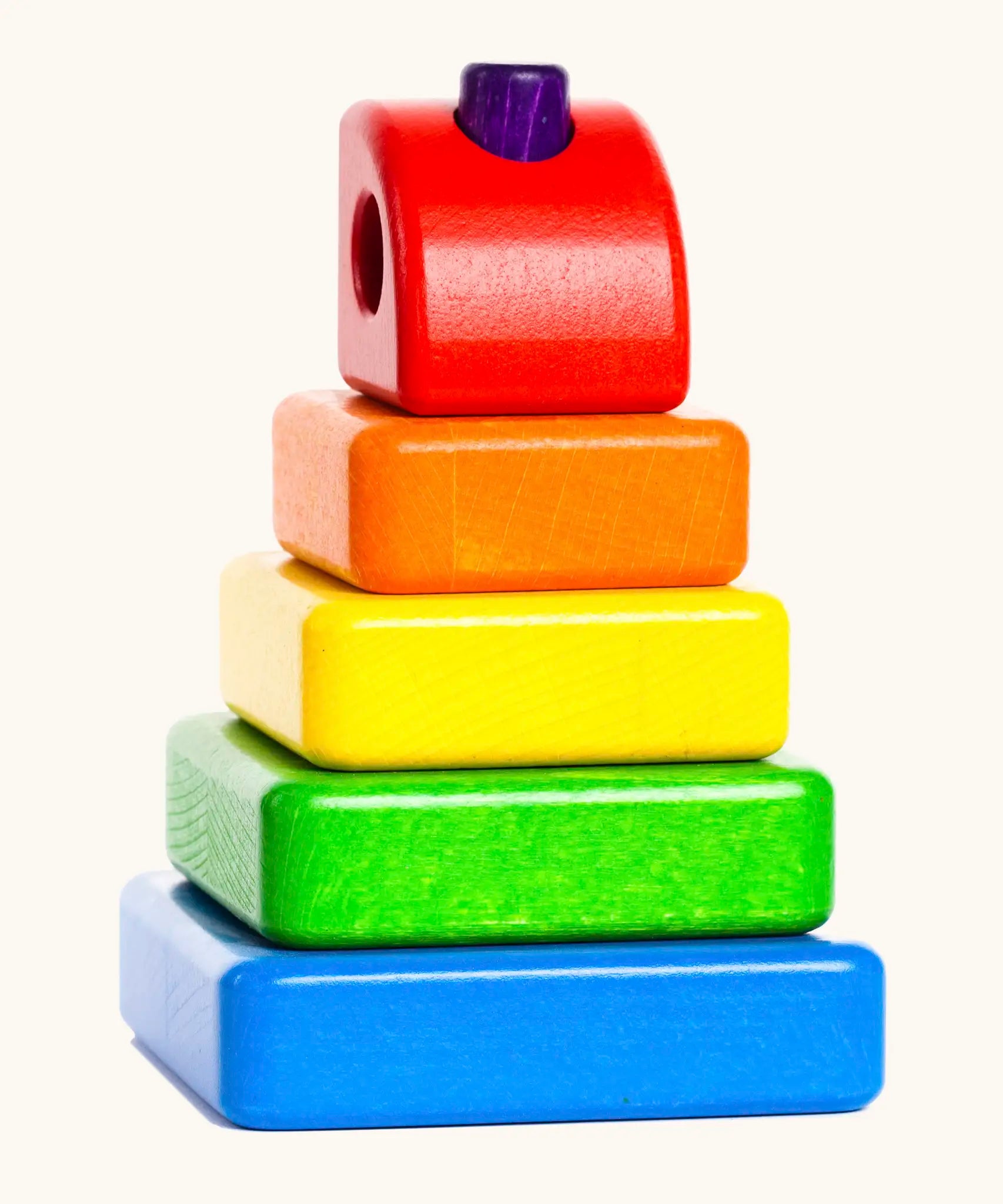 Bajo tower stacker puzzle set showing 5 wooden coloured blocks threaded through a purple pin