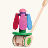 Bajo wooden rainbow flower push along toy showing the coloured petals fully closed and pointing down