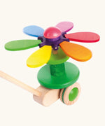 Bajo wooden rainbow flower push along toy showing the coloured petals fully opened and spinning around