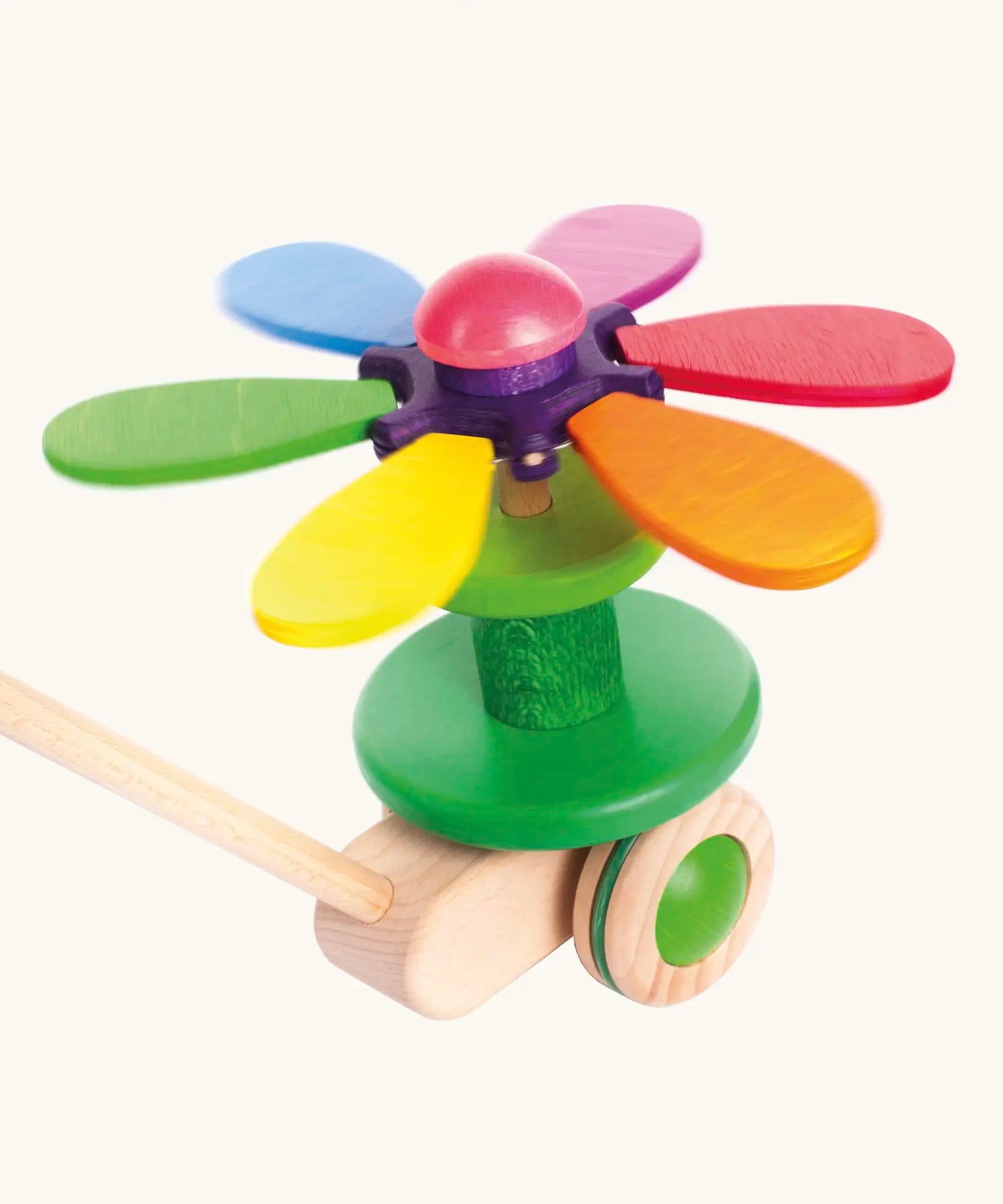 Bajo wooden rainbow flower push along toy showing the coloured petals fully opened and spinning around